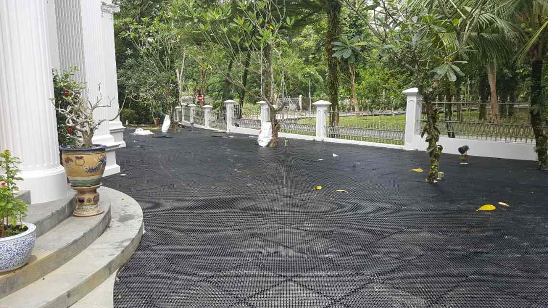 Black drainage-cell base laid across the forecourt at the heritage bungalow