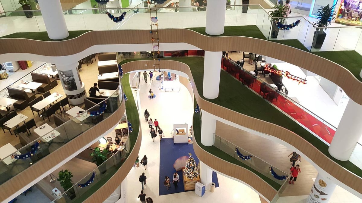 Artificial grass landscaping across multiple mall levels at White Sands, Singapore