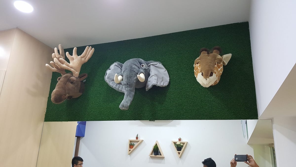 Artificial grass feature wall with animal decor at a childcare in Ang Mo Kio, Singapore