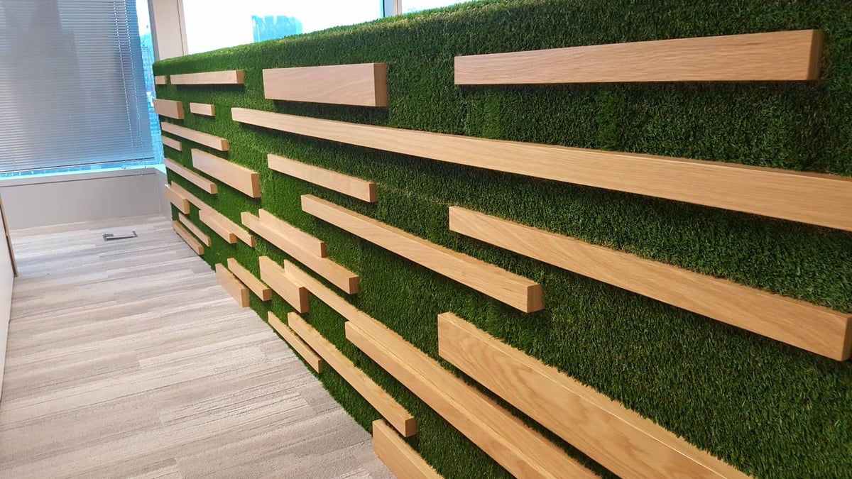Artificial grass feature wall with timber battens in an office at Capital Tower, Singapore