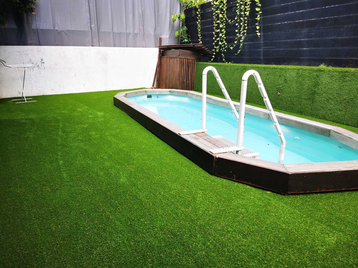 Artificial grass poolside lawn wrapping a pool at Barker Road, Singapore