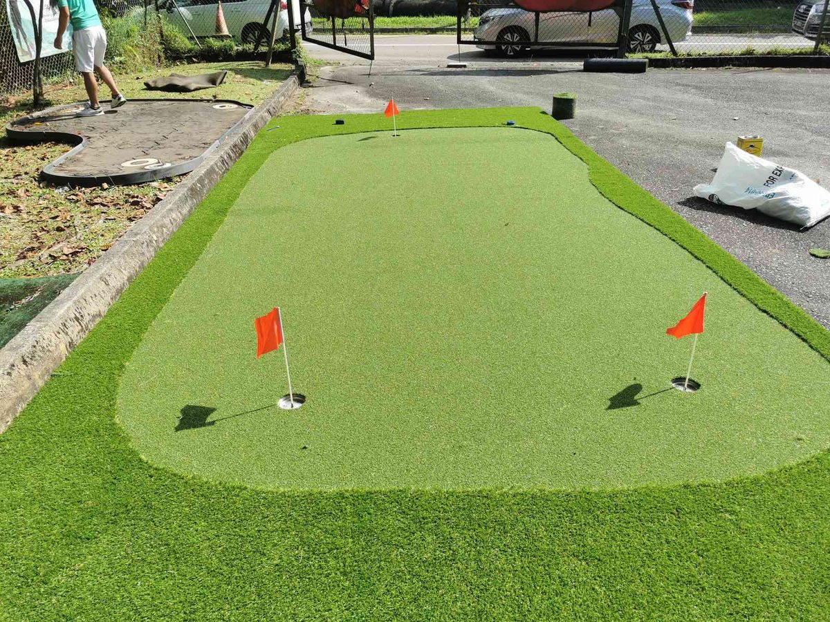 Landscaped putting green framed by planting for a Takashimaya golf feature, Singapore