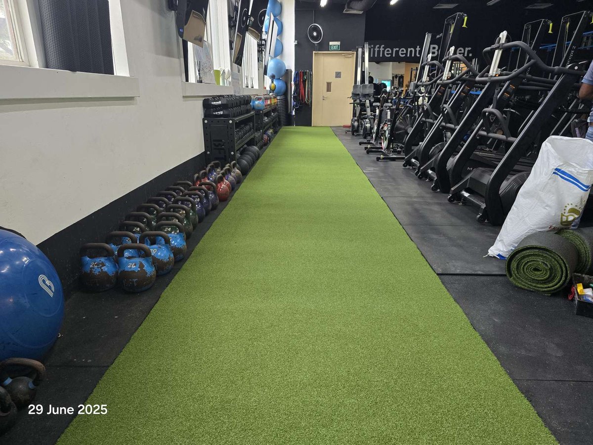 Artificial grass training lane laid the length of the studio floor at BFT Orchard gym, Singapore