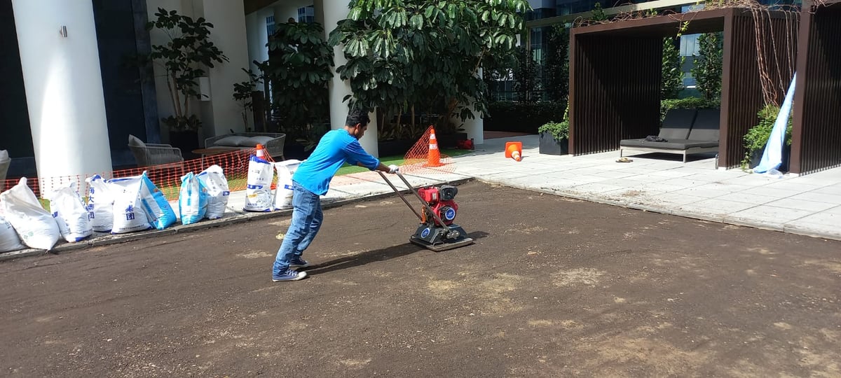 Compacting the milled base with a plate compactor at One Shenton