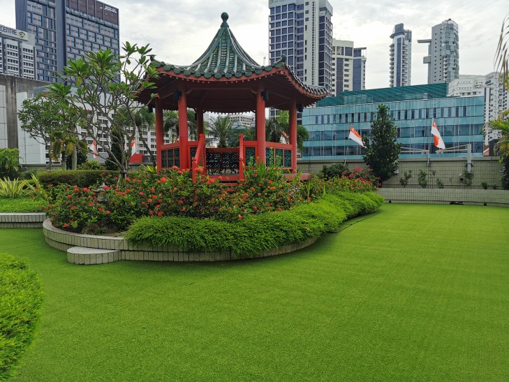 Premium Namgrass artificial grass rooftop garden with pagoda in Singapore, lush and flawless