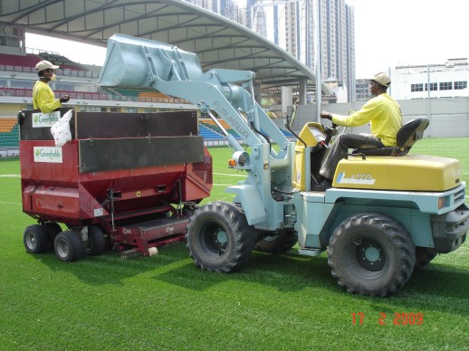Performance rubber infill being spread across the pitch by machine at Jalan Besar Stadium, February 2009