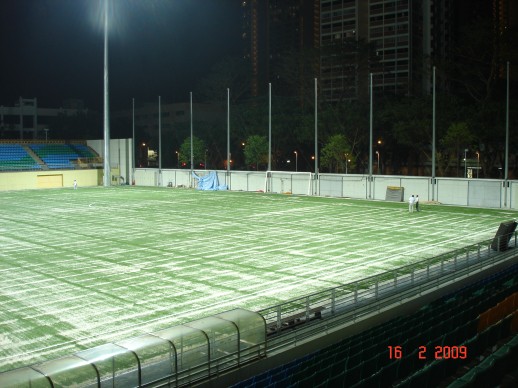 Kiln-dried sand being brushed into the pitch under floodlights at Jalan Besar Stadium, February 2009
