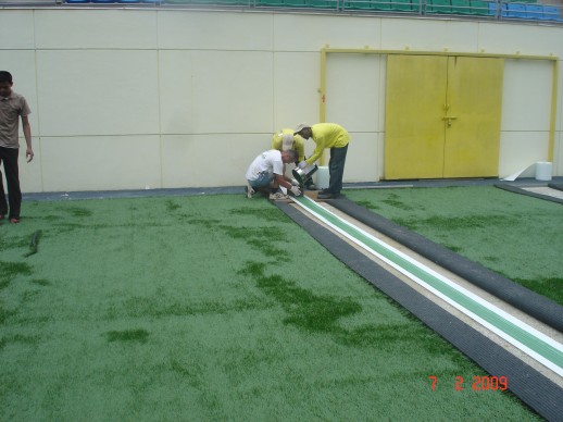 The team joining and bonding turf seams at Jalan Besar Stadium, February 2009