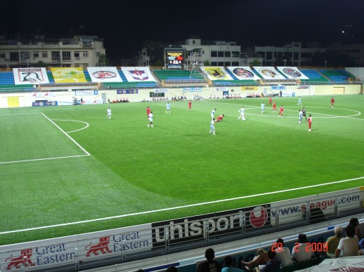 A live S.League match under floodlights on the completed FIFA-certified pitch at Jalan Besar Stadium